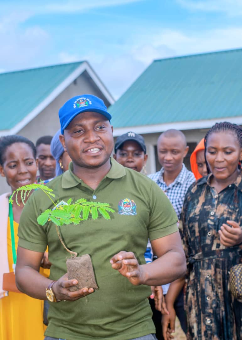 Community leader displaying a tree seedling